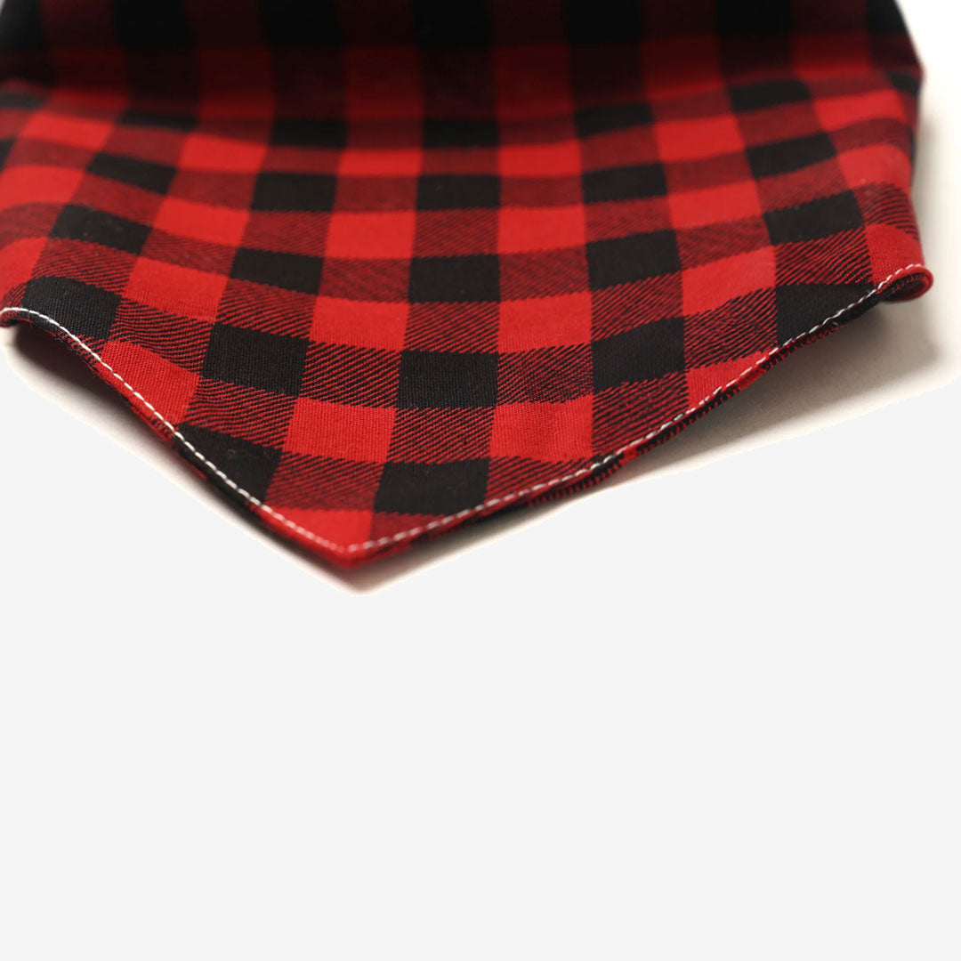 Close up fabric detail of a 100% cotton plaid dog bandana in red and black check