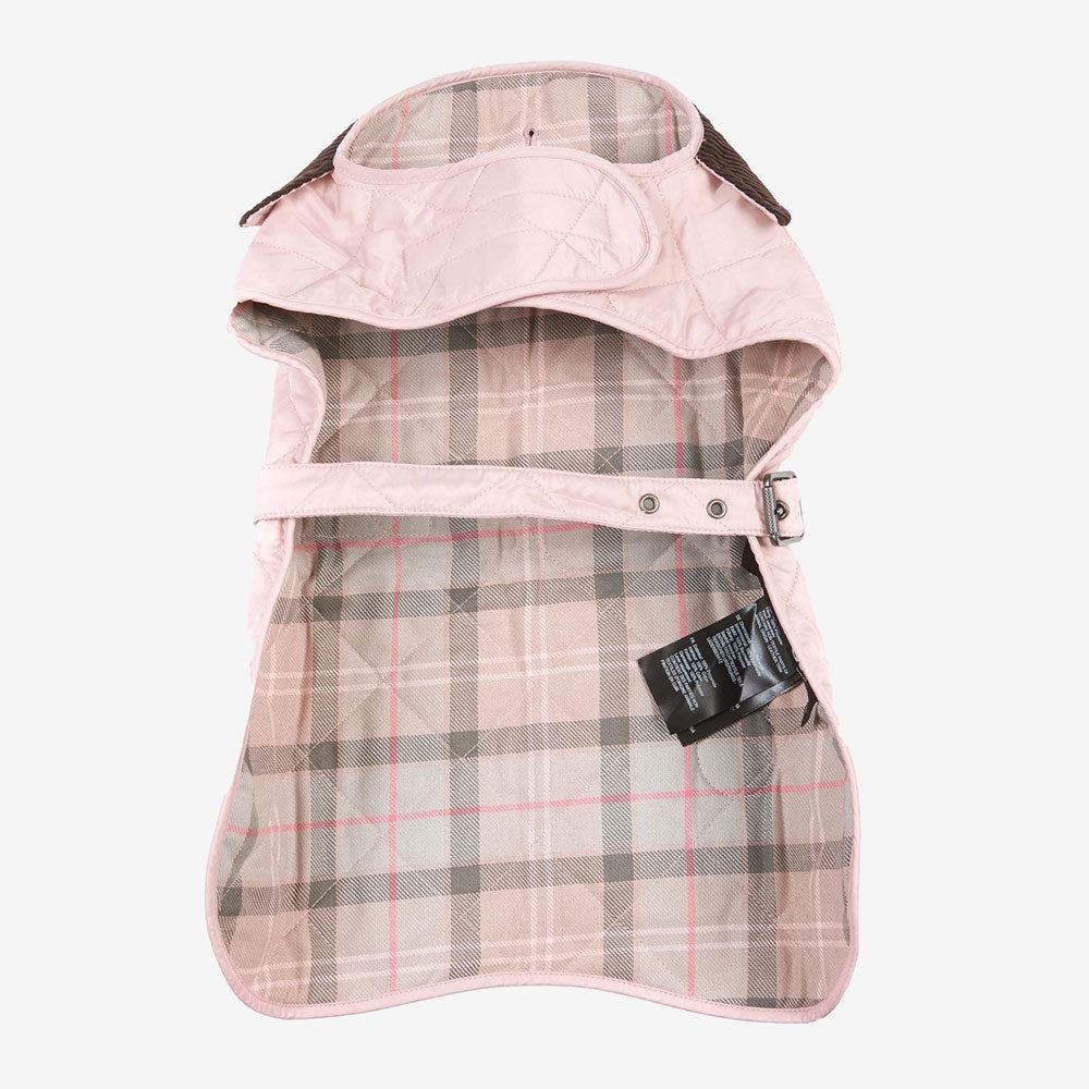 Light pink quilted pet jacket with a plaid lining, featuring a buckle and tag, displayed from an overhead view.