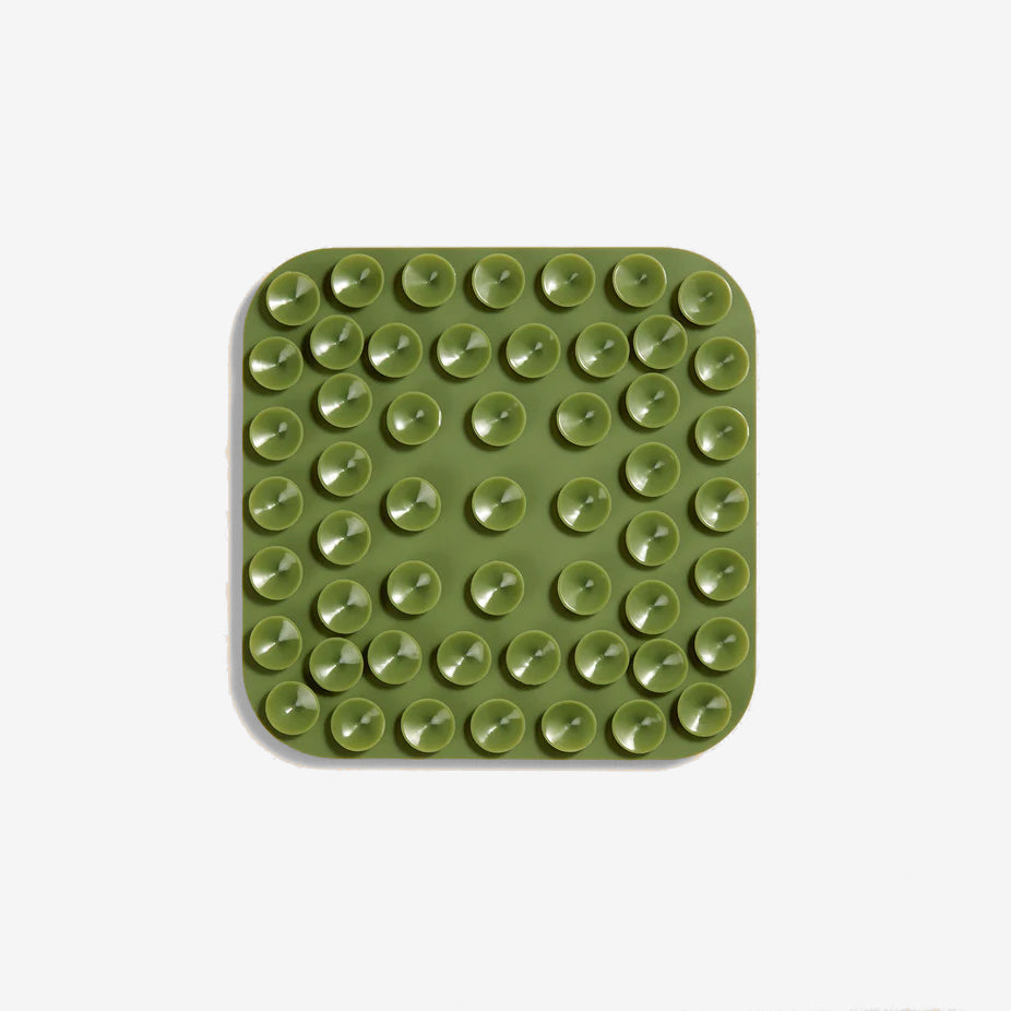 the back of a khaki green lickimat showing the suction cups