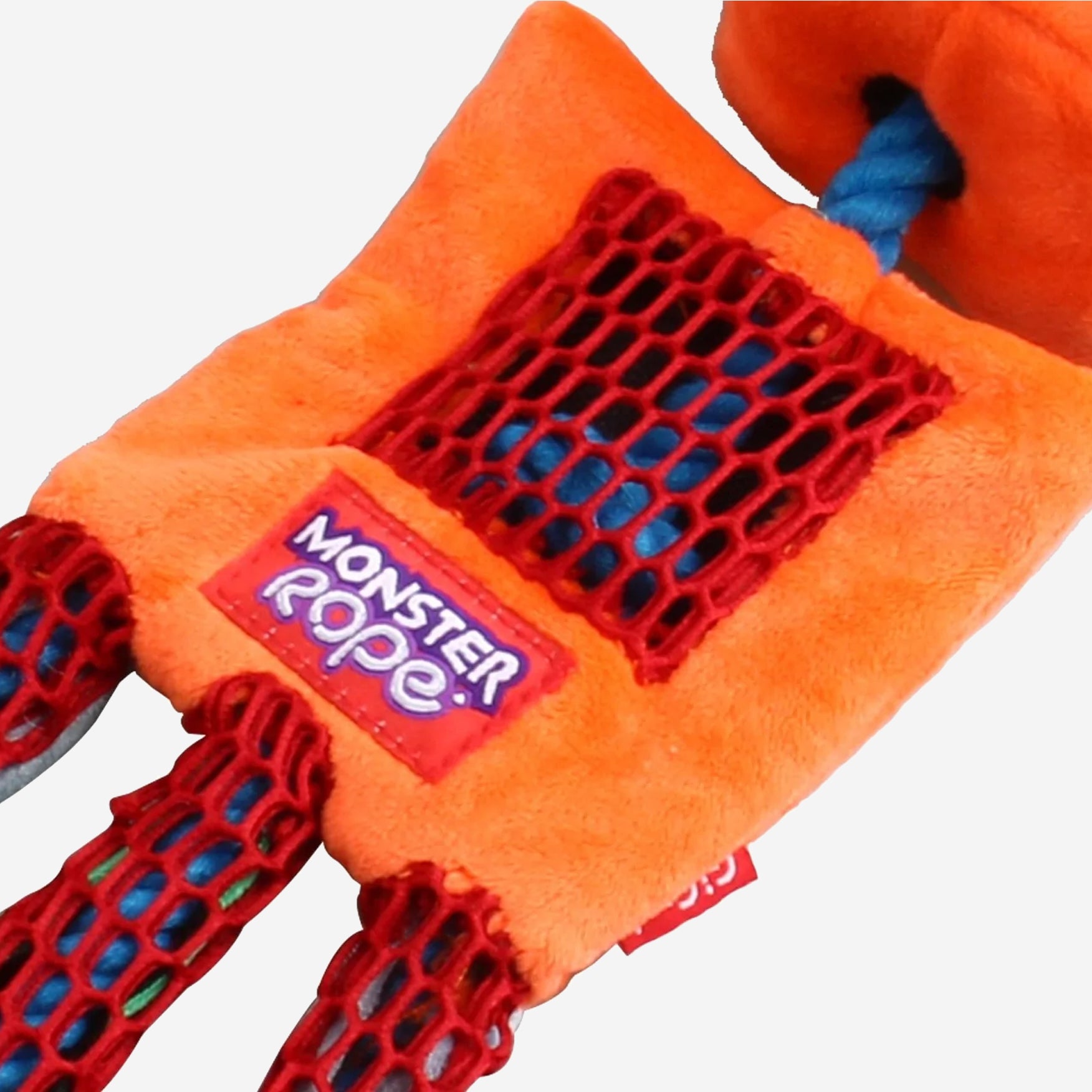 A three quarter overhead, close up view of a plush orange rope dog toy.