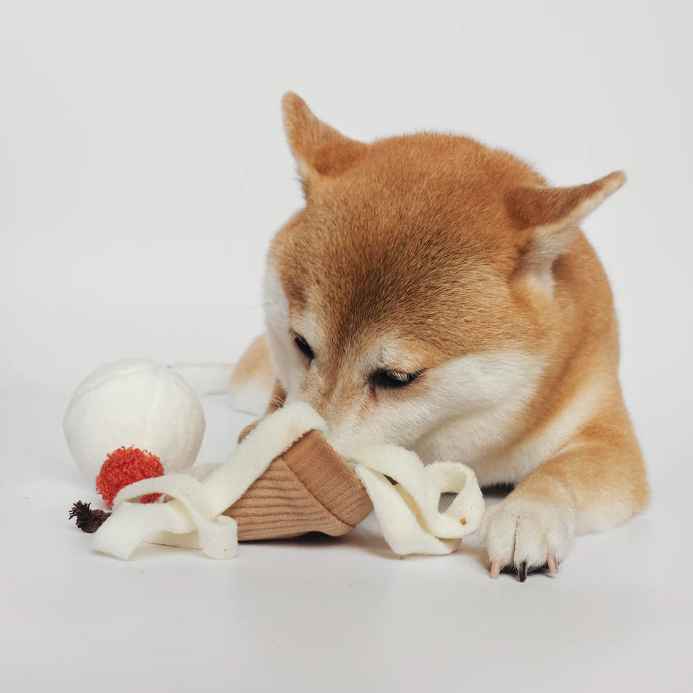 Dog snuffling inside Lambwolf Collective's plush ice cream pop dog toy.