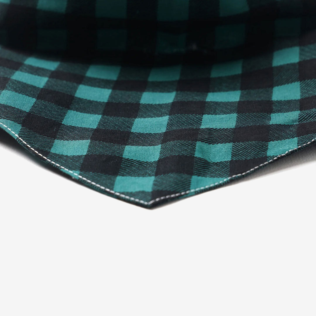 Close up of a plaid checkered dog bandana in green and black