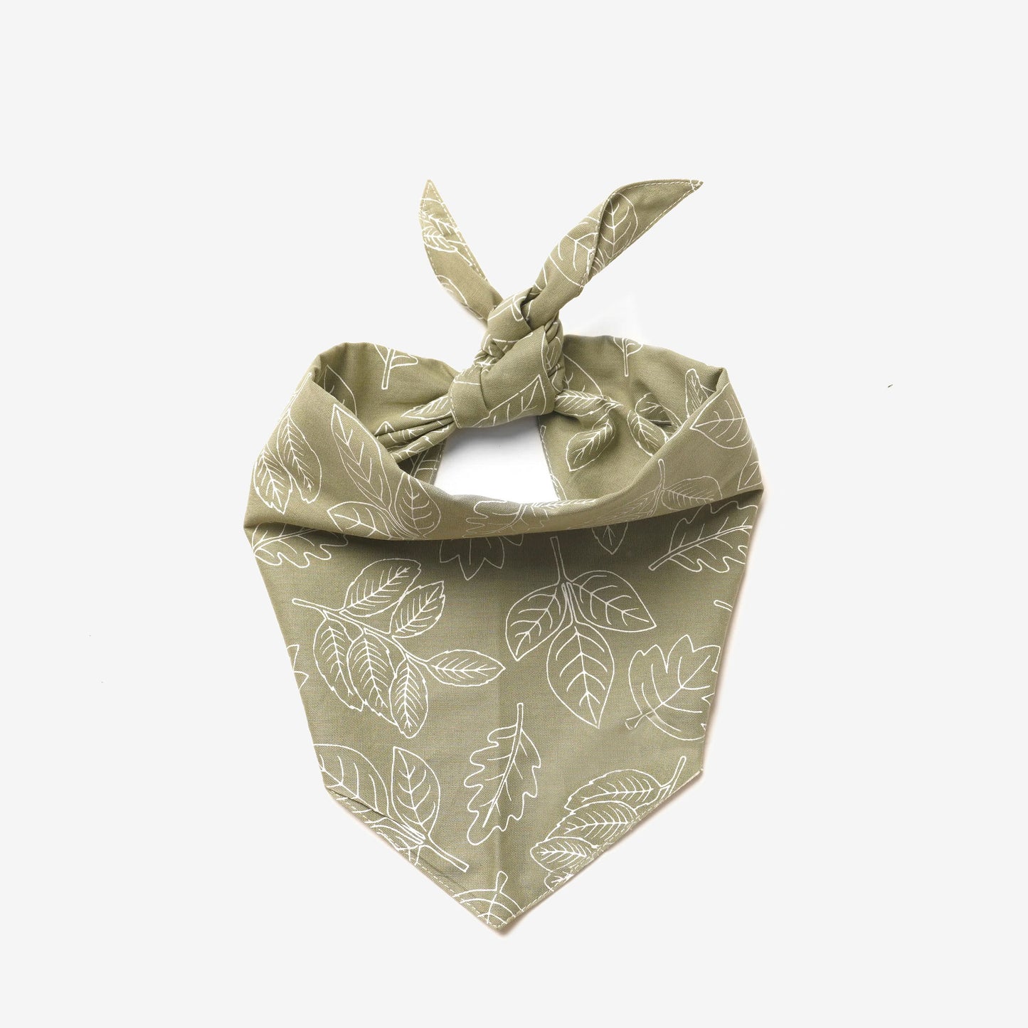 A 100% cotton dog bandana patterned with white outlined leaves on a rust base 