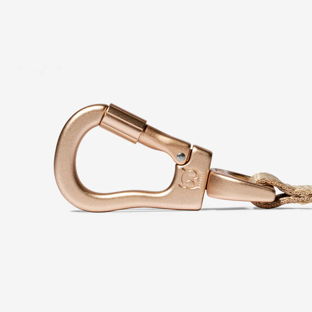 Close up of Zee Dog carbon air leash anodized aluminum hook in a rose gold finish.