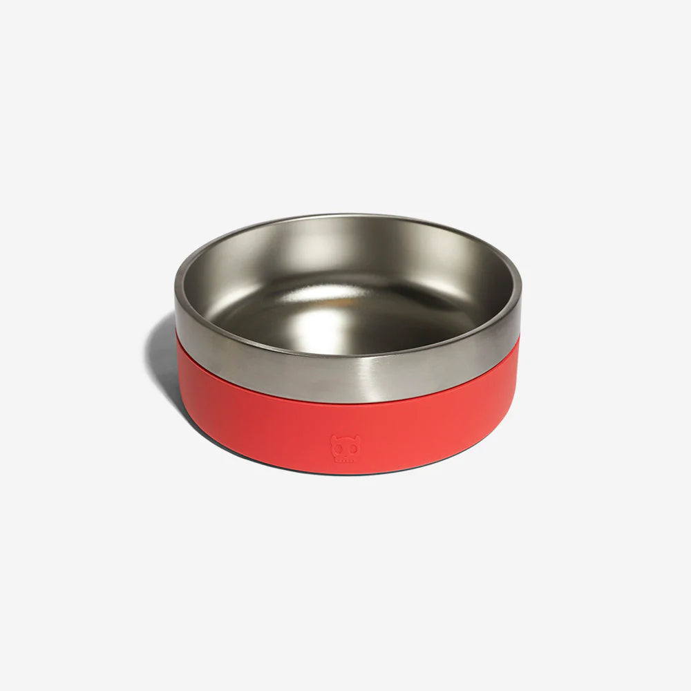 A stainless steel dog bowl with a red rubber exterior by Zee Dog resting against a plain white background.