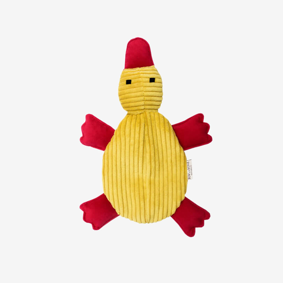 A yellow plush duck dog toy with a red bill and feet