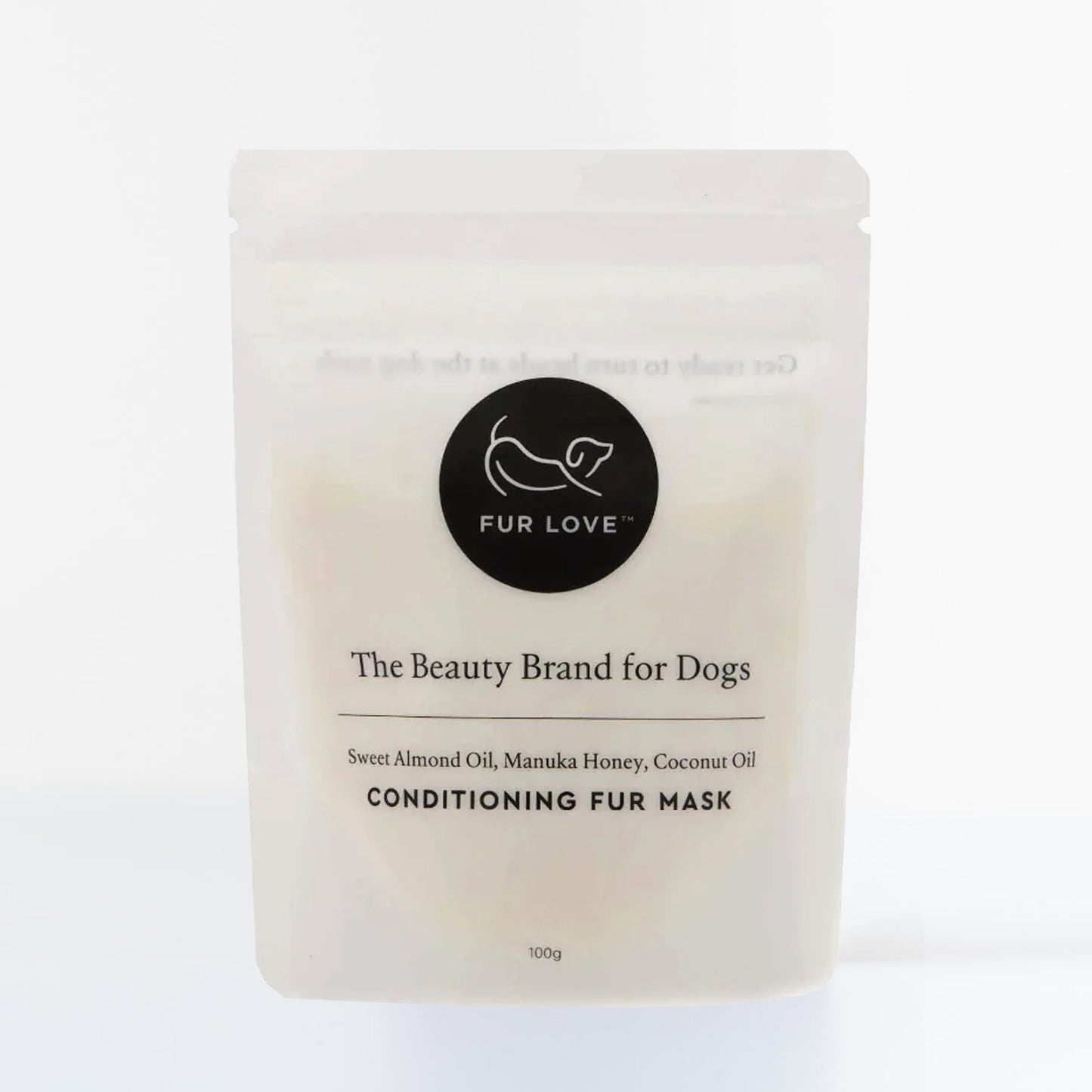 A cream pouch with black text and logo. The pouch is filled with a conditioning fur mask for dogs.