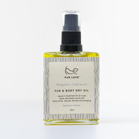 A glass bottle filled with bergamot and cedarwood oil for dogs.